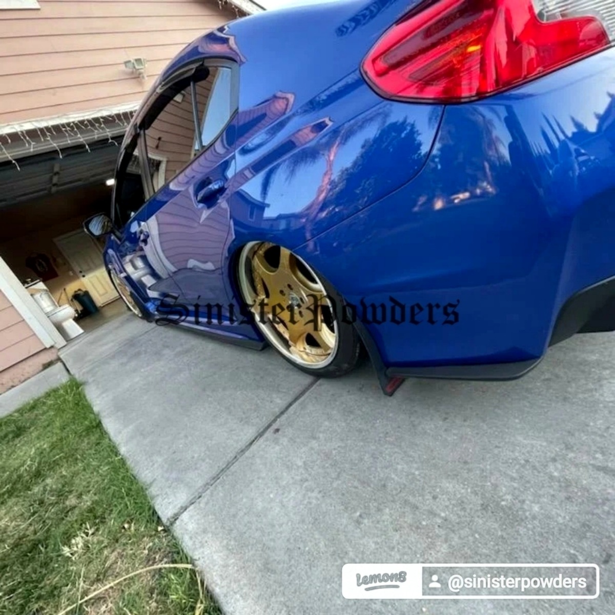Blue lowered car with gold wheels